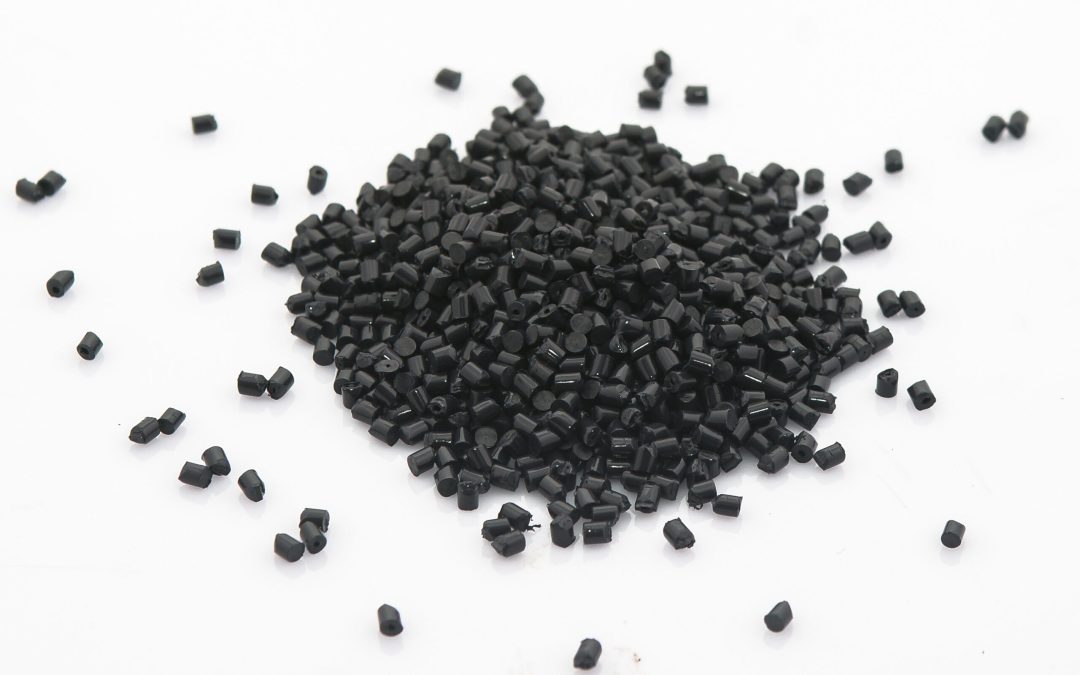 EPDM rubber granules .Black Colored Rubber Granules on white background. Plastic polymer granules.